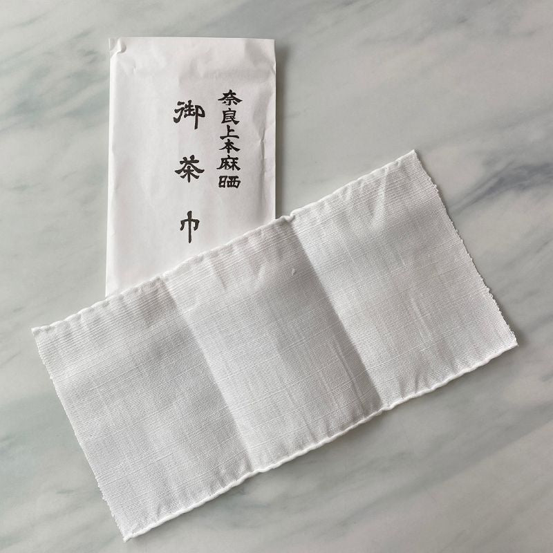 Nara Tea Co.'s 5/10 Set of Chakin product in a white paper sachet package with the product name and a white cloth Chakin