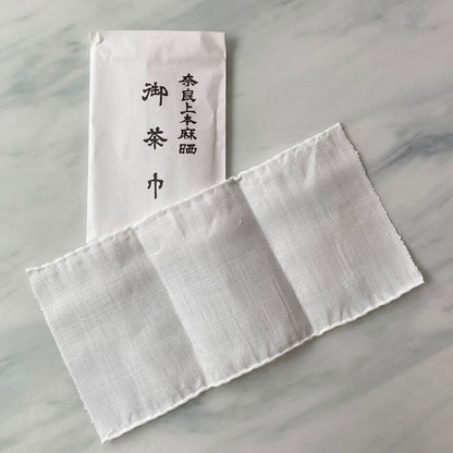 Nara Tea Co.'s 5/10 Set of Chakin product in a white paper sachet package with the product name and a white cloth Chakin