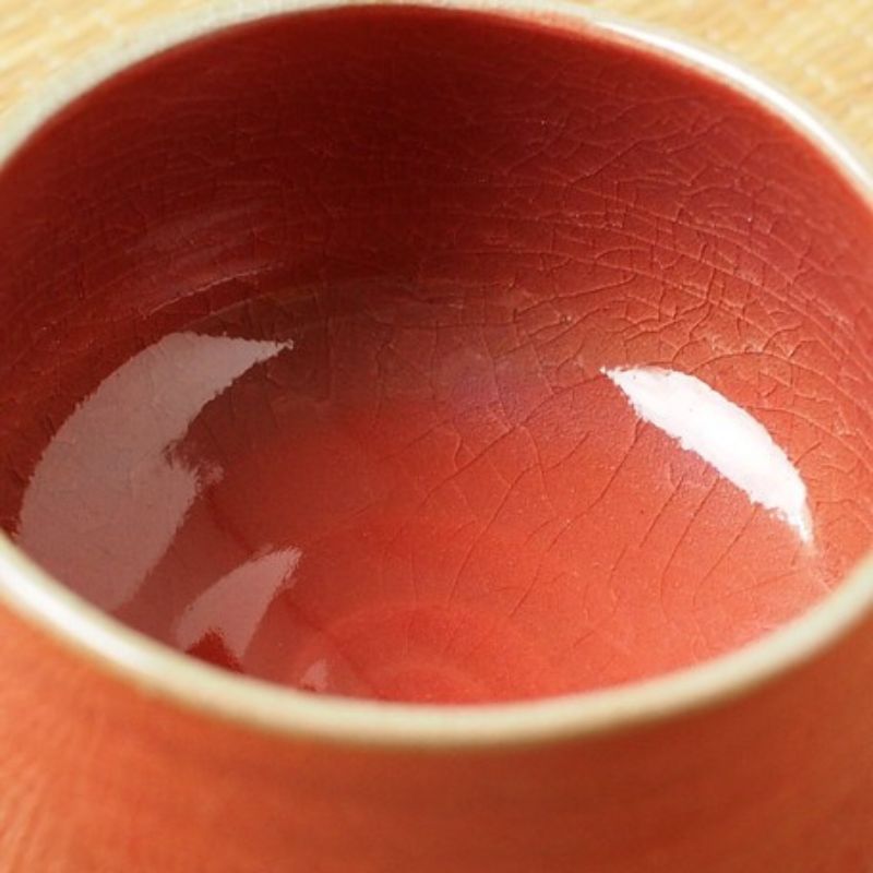 Enlarged photo of Nara Tea Co.'s Akaraku Matcha Tea Bowl, an elegant autumn color with a glossy texture, viewed from above at an angle.