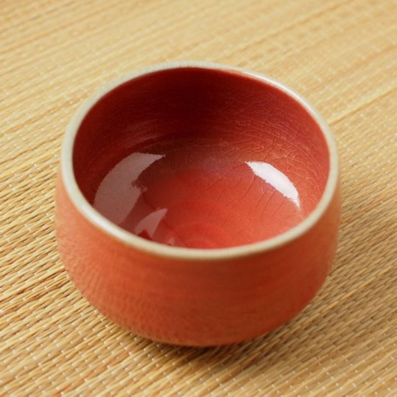 Akaraku Matcha Tea Bowl from Nara Tea Co. with a glossy texture and elegant fall color, seen from above at an angle.