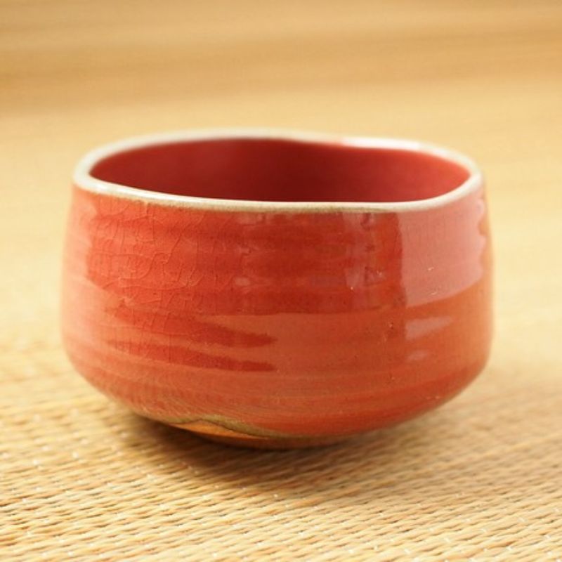 Akaraku Matcha Tea Bowl from Nara Tea Co. with a glossy texture and elegant autumn color, viewed from the front diagonally.