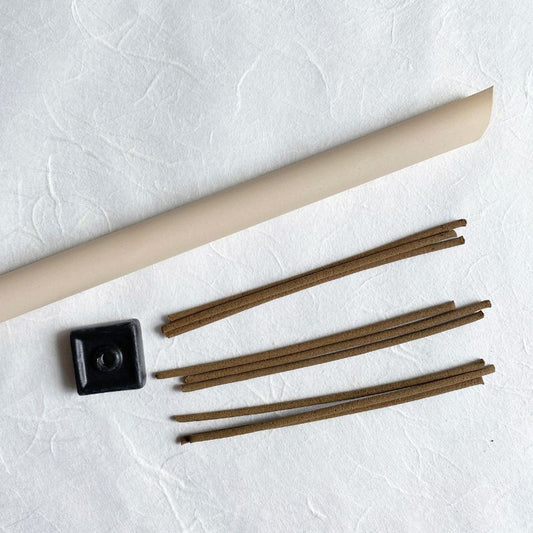Nara Tea Co.'s Nara-Tea-Handcrafted-Incense-With-Stand, with incense sticks and a square black stand, seen from directly above the front.