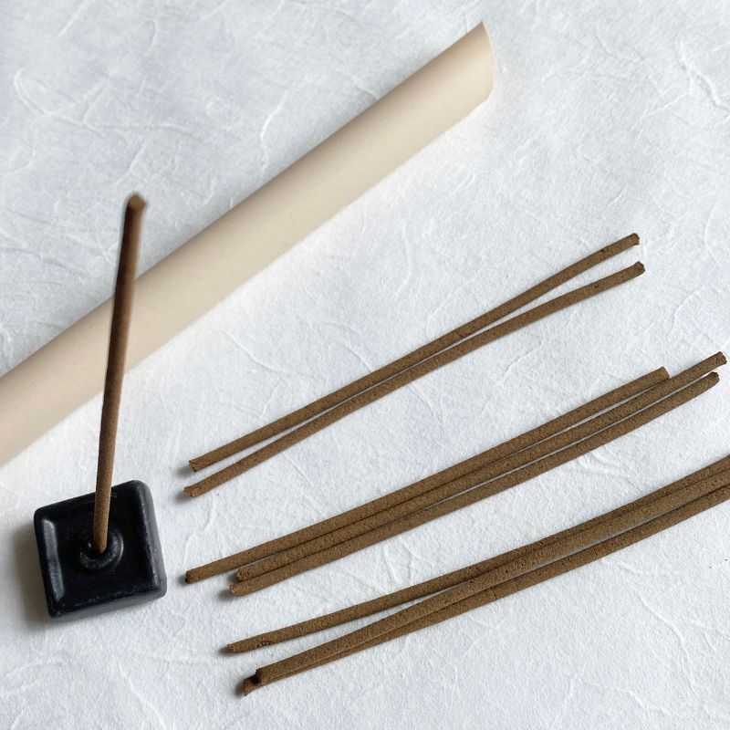 View from directly above the front of a square black stand with incense sticks in a product called Nara-Tea-Handcrafted-Incense-With-Stand by Nara Tea Co.