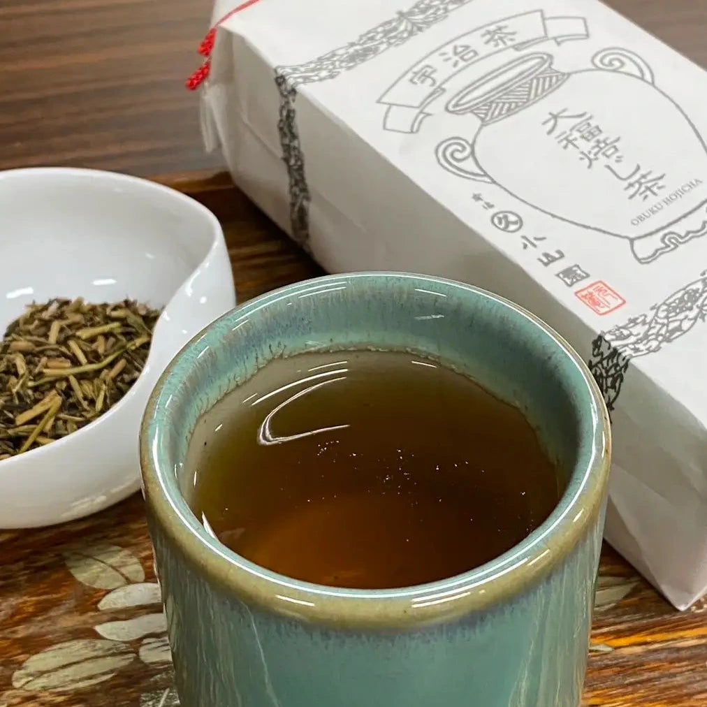 Tea cup with tea leaves and packaging on a wooden surface