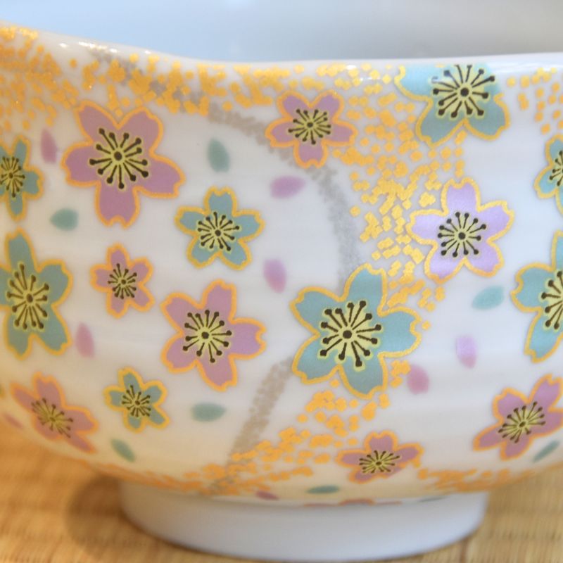 Decorative ceramic bowl with floral pattern on a wooden surface