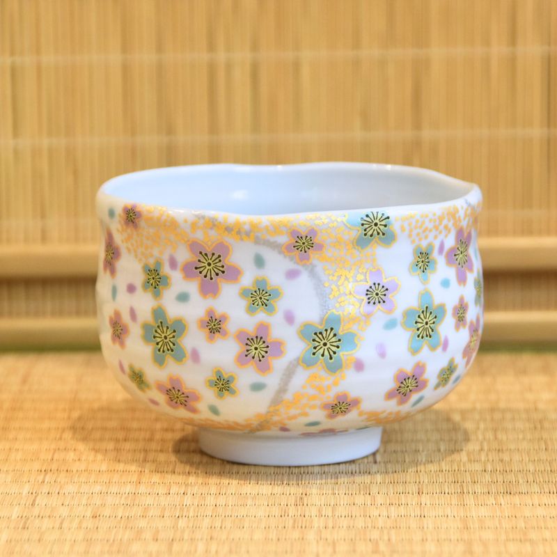 Ceramic cup with floral pattern on a bamboo mat