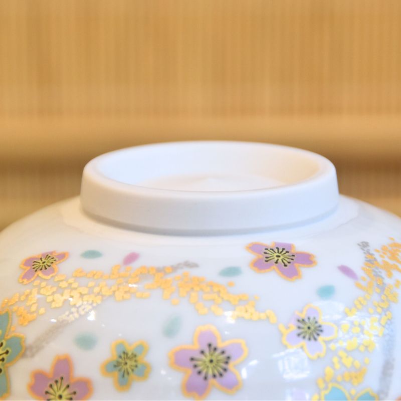 Close-up of a ceramic bowl with floral patterns on a wooden surface