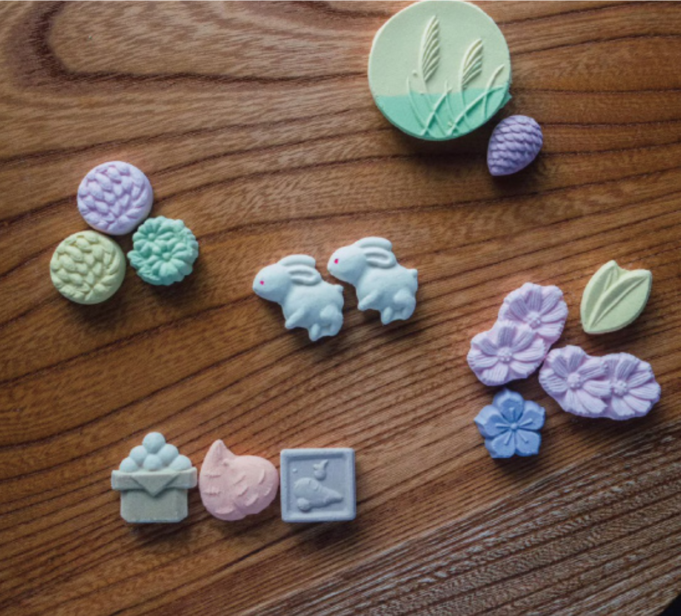 Pastel-colored clay stamps on a wooden surface