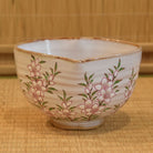 Ceramic bowl with floral design on a woven mat