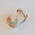 Decorative folded fabric piece on a light background