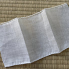 Gray fabric folded on a textured brown surface
