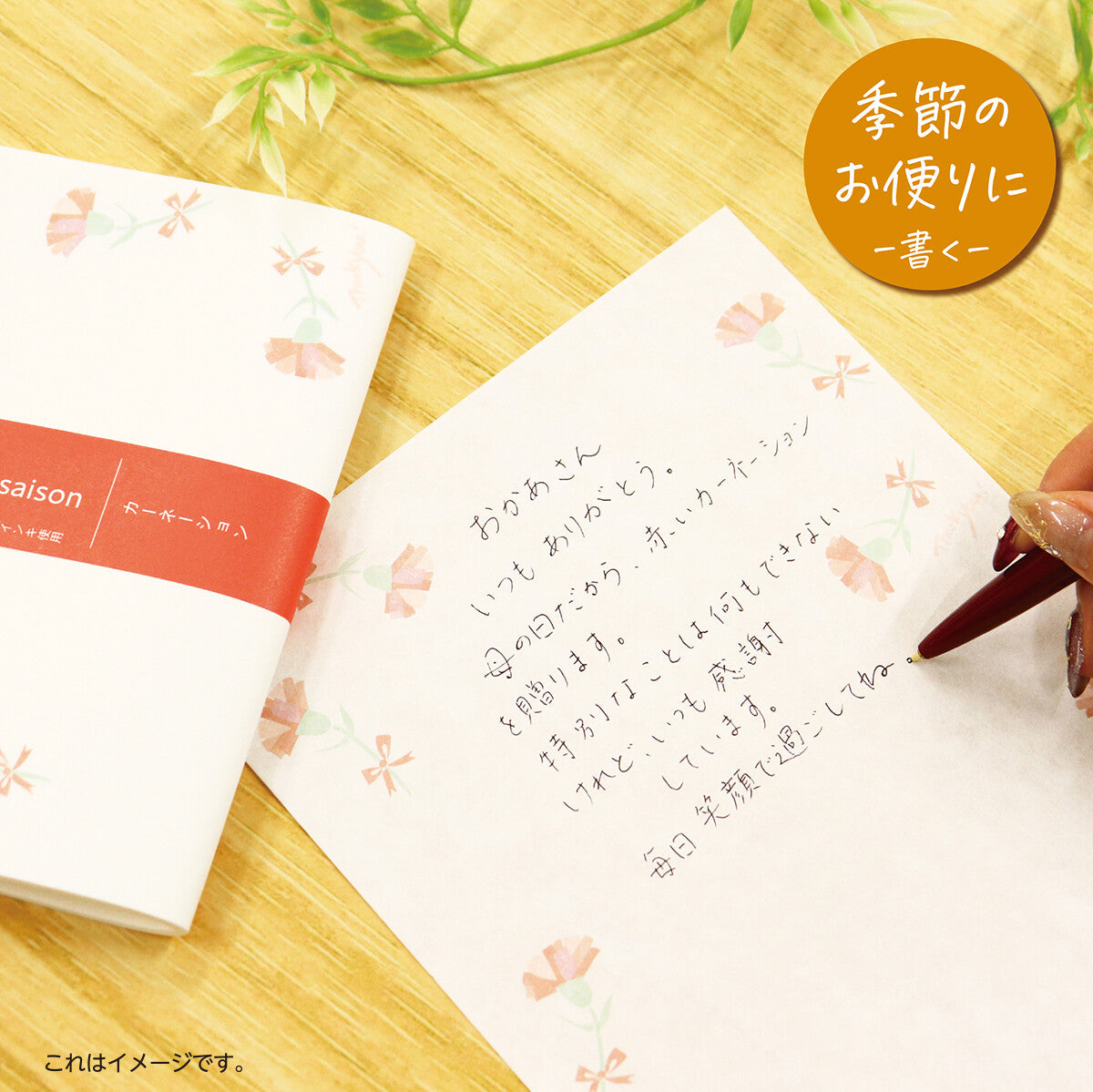 Handwritten message on a floral notebook with a pen on a wooden surface