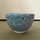 Ceramic bowl with floral design on a textured surface