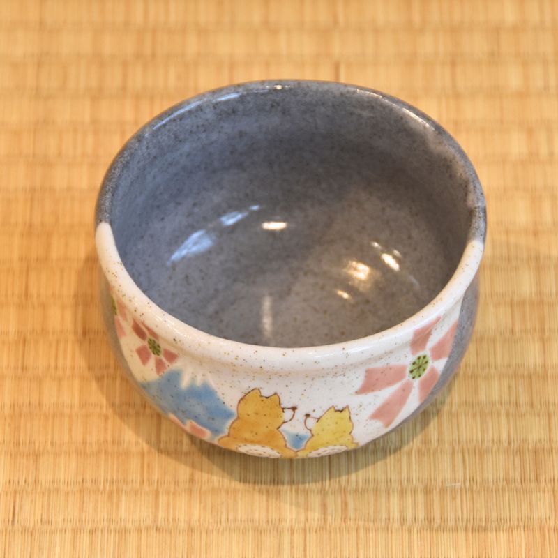 Ceramic bowl with floral patterns on a wooden surface