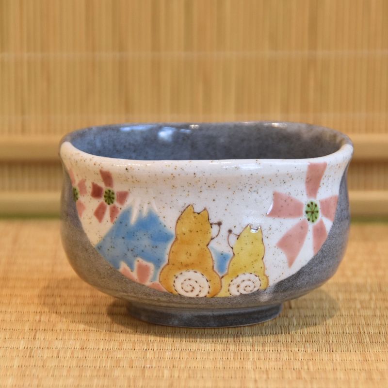 Ceramic bowl with shiba dog design on a woven mat