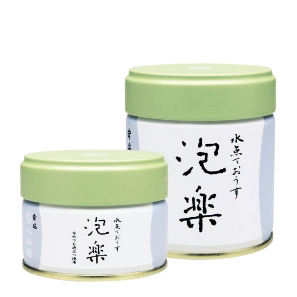 Two small matcha containers with green lids and white bodies featuring Japanese text on a white background.