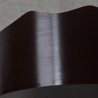 Close-up of a textured black strip on a neutral background