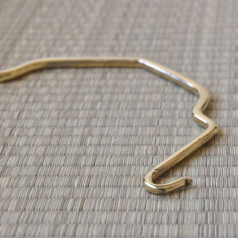 Gold headband on a textured beige background