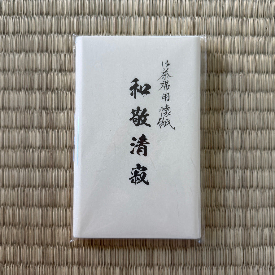 White package with black text on a woven mat background