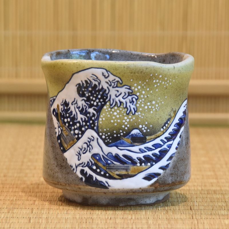 Ceramic cup with wave design on a woven mat background