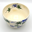 Top interior view of the Aomomiji matcha bowl showing green and blue maple leaves with flowing water around the inner rim