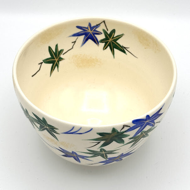 Top interior view of the Aomomiji matcha bowl showing green and blue maple leaves with flowing water around the inner rim