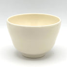 Plain side view of the Aomomiji Kyo Ware matcha bowl showing its softly textured ivory glaze and rounded ceramic form