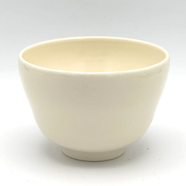 Plain side view of the Aomomiji Kyo Ware matcha bowl showing its softly textured ivory glaze and rounded ceramic form
