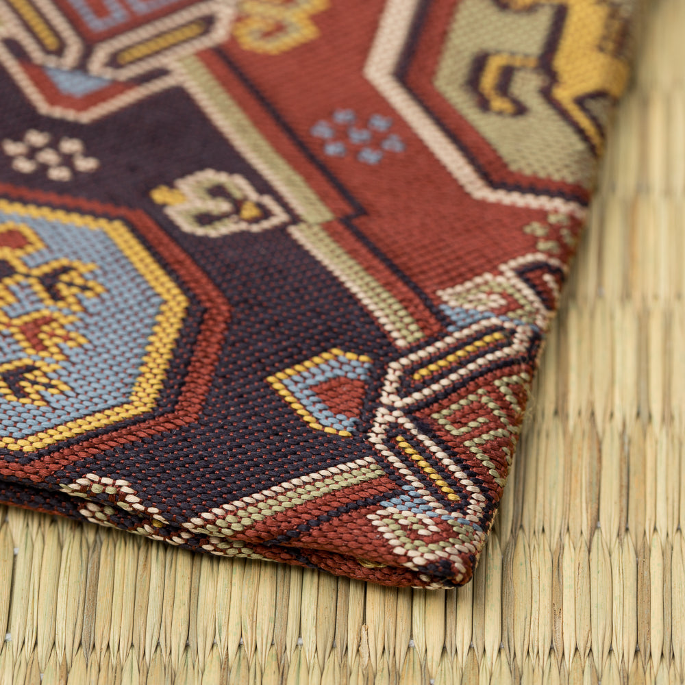 Folded corner of the Arisugawa Uma Mon kobukusa showing its hand-sewn edge and red, blue, and gold brocade.