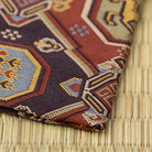 Folded corner of the Arisugawa Uma Mon kobukusa showing its hand-sewn edge and red, blue, and gold brocade.