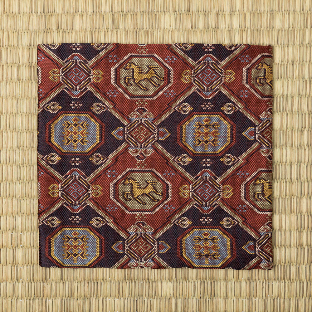 Full view of the kobukusa featuring repeating horse medallions, seven-treasure motifs, and geometric clouds.