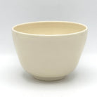 Reverse view of the Ayame Kyo Ware chawan showing its simple ivory glazed surface and rounded form