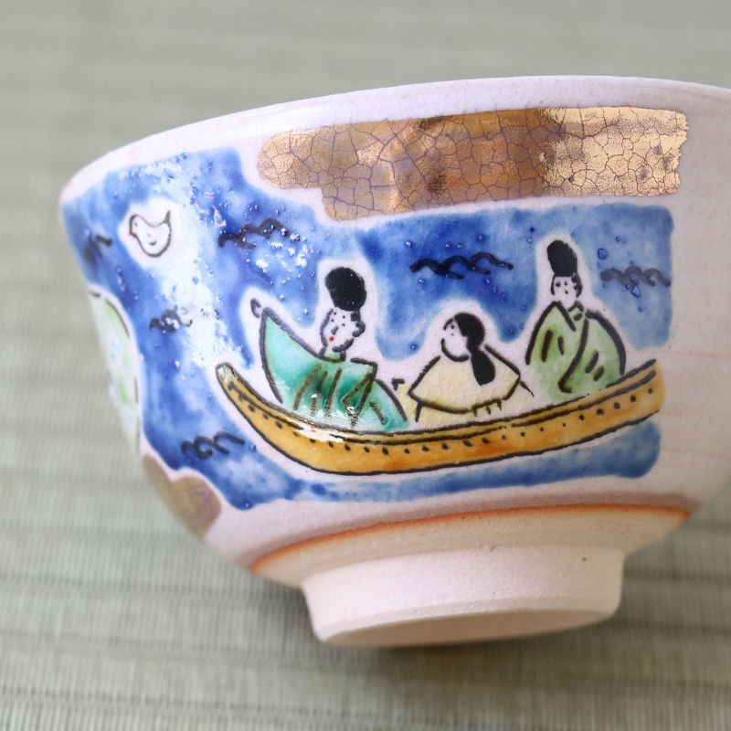 Side view of the Japanese matcha bowl showing figures in a boat beneath the blue starry sky design