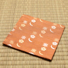 Angled view of the hand-sewn rose Chitose-bon kobukusa resting on a tatami surface.