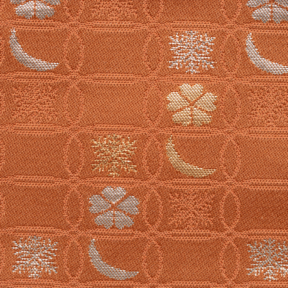 Close-up of rose Nishijin silk brocade with overlapping shippo circles, snow crystals, crescent moons, and flowers.