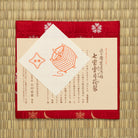 Wine red Shippo Setsugekka Chitose-bon kobukusa displayed with its Japanese paper product labels.