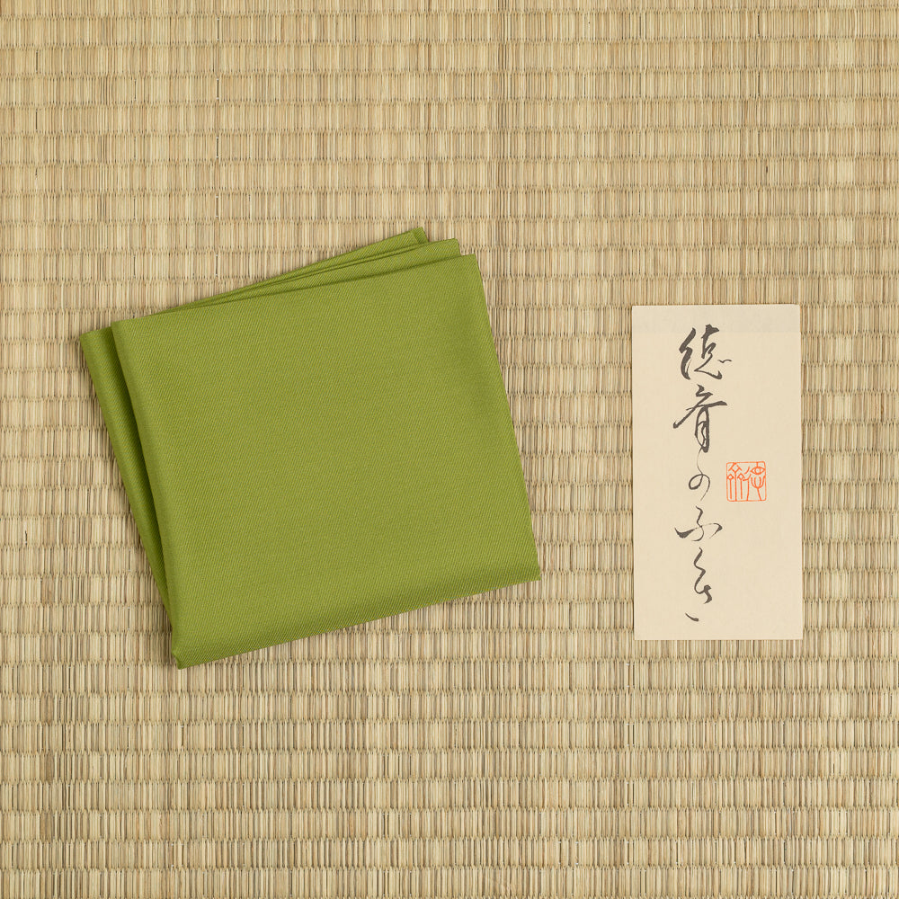Choji Moss Green silk fukusa displayed on tatami with Kitamura Tokusai label