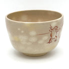 Side view of the Choju-Giga matcha bowl highlighting playful hand-painted animal figures on the warm beige glaze