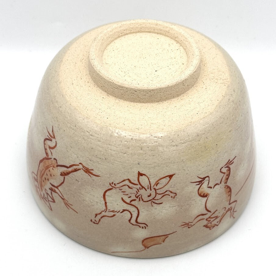 Underside view of the hand-painted Choju-Giga Kyo Ware chawan showing its ceramic foot and animal decoration