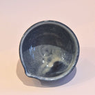 Top view of the katakuchi matcha bowl showing its dark blue-gray glazed interior and pouring lip.