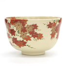 Side angle of Eika Miyaji matcha bowl showing red maple leaves and delicate decorative accents