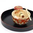 Autumn maple leaves matcha bowl by Eika Miyaji displayed with Japanese tea ceremony utensils