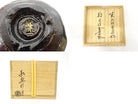 Detail collage showing the circular foot and underside mark of the matcha bowl together with Japanese calligraphy on its wooden storage box.