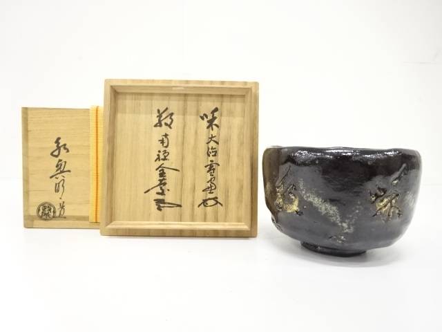 Pre-owned Eiko Meido Mandokoro Kiln matcha bowl with a midnight glaze and gold botanical accents displayed beside its inscribed wooden storage box.