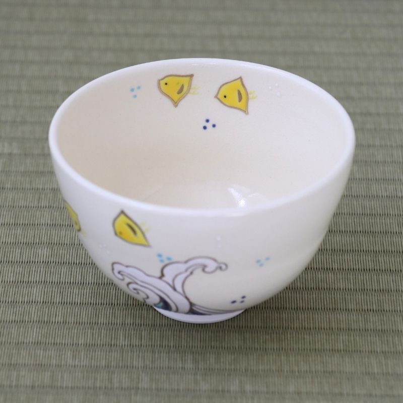 Top interior view of the Eishin Kato Nami Chidori matcha bowl showing yellow Chidori birds inside the white glazed bowl and stylized waves on the exterior