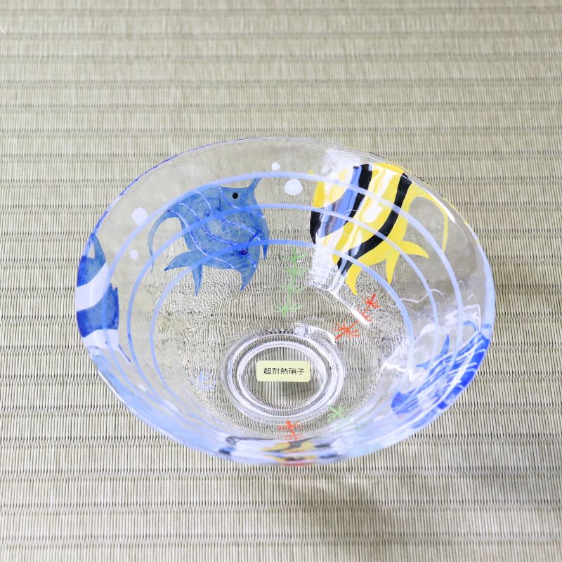Handcrafted Japanese glass matcha bowl with blue and yellow angelfish design viewed from above
