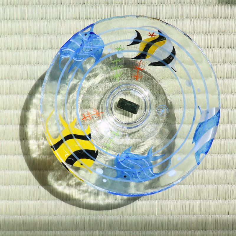 Top view of transparent glass matcha bowl featuring blue and yellow angelfish decoration