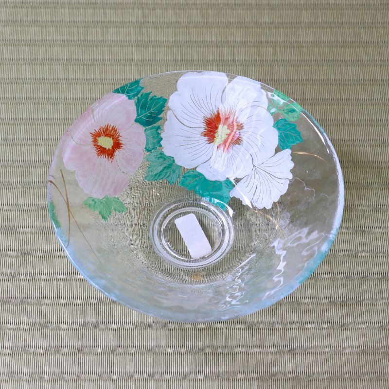 Handcrafted Japanese glass matcha bowl with pink and white Rose of Sharon flowers viewed from above