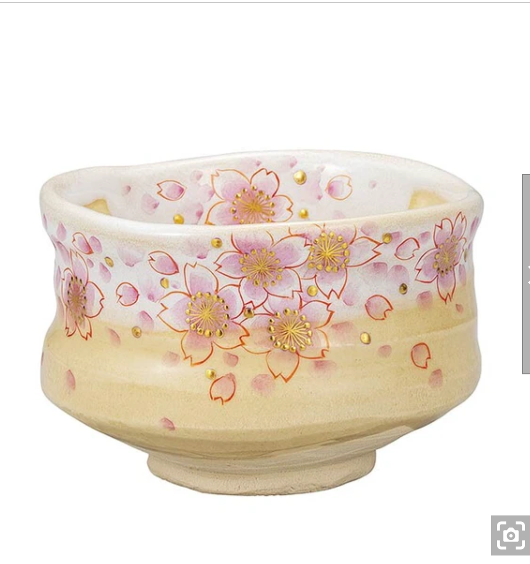Front view of a hand-painted Kutani Ware matcha bowl covered with pink cherry blossoms, gold leaf accents, and fine gold outlines on a warm ivory glaze.