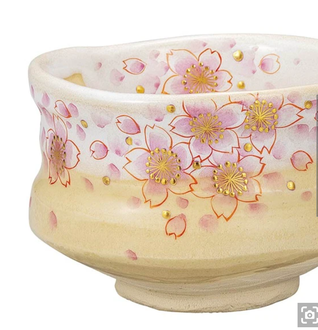 Right angled view of the hand-painted sakura matcha bowl showing its rounded chawan form, raised foot, and luminous gold-accented blossoms.